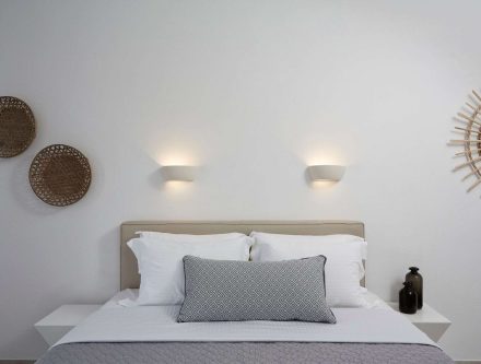 Elegant bedroom with double pool view at Mr and Mrs White Hotels Cyclades. Modern decor and relaxing.