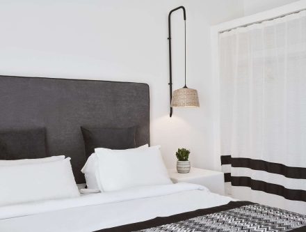Modern junior suite with mountain view, cozy bed, and stylish decor.